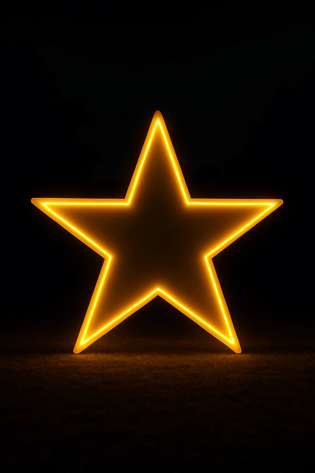 Large glowing star-shaped light installation in warm golden yellow, displayed outdoors against a dark night backdrop