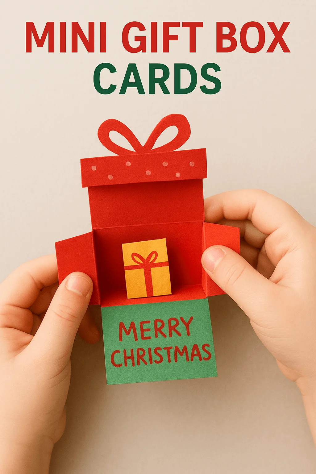 Child holding a handmade mini gift box Christmas card made of red and green paper, shaped like an open present with a small yellow gift inside and the message ‘Merry Christmas’ written on the bottom flap.