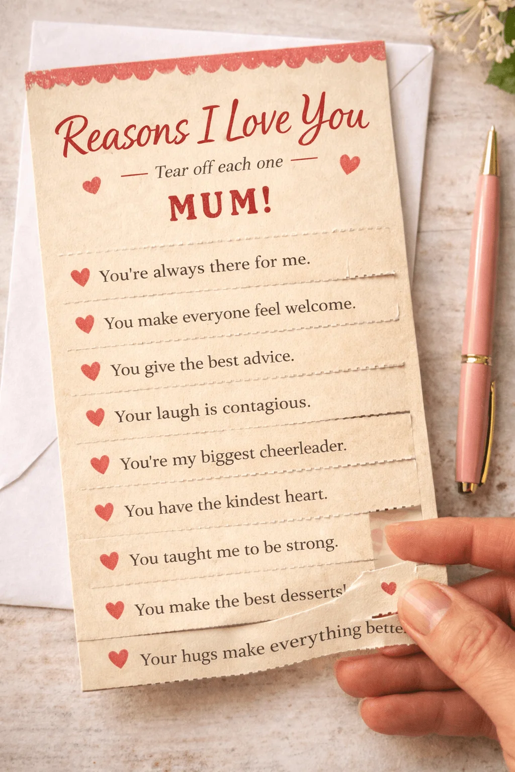 Tear off reasons I love you mum card with heart icons and a hand pulling a strip to reveal messages on a pastel paper background
