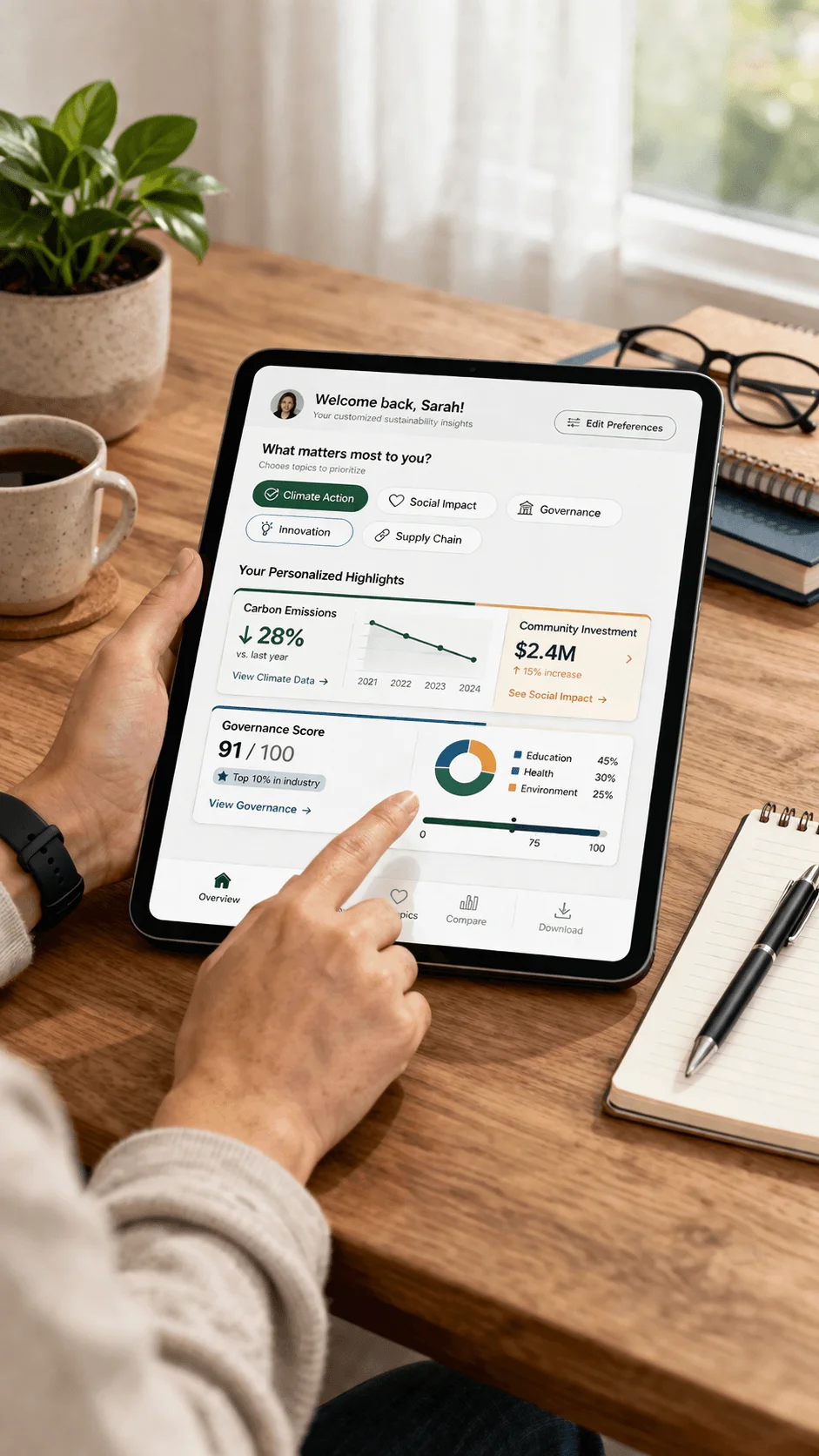 Person using a tablet displaying a personalized sustainability dashboard with carbon emissions governance score and community investment metrics on a desk with coffee plant and notebook nearby