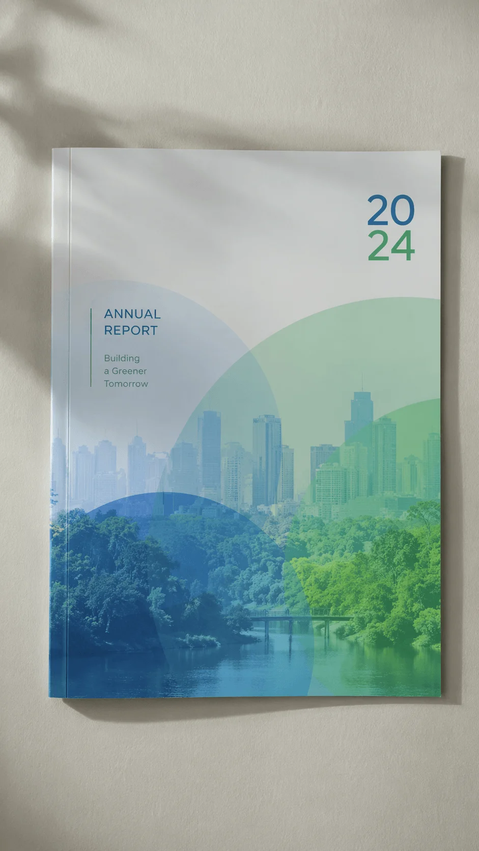 Annual report 2024 cover with layered transparent design showing a city skyline blended with green landscape and water symbolizing sustainability and building a greener tomorrow.