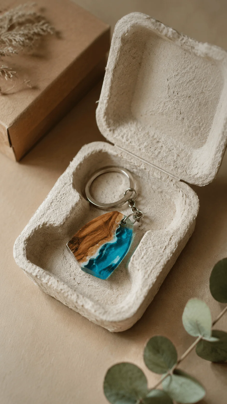 Handmade resin and wood keychain presented in eco friendly biodegradable molded fiber packaging with natural earthy aesthetic and minimalist sustainable design