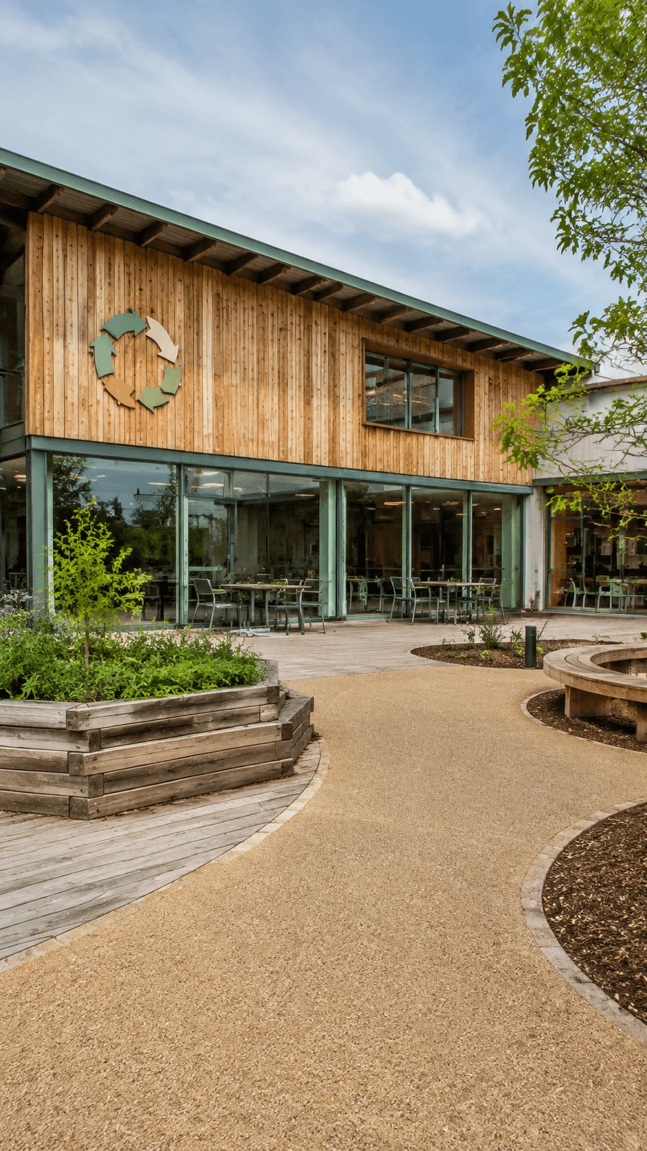 Circular school design featuring a sustainable building made with eco friendly materials landscaped outdoor spaces and architecture focused on recycling reuse and environmental learning