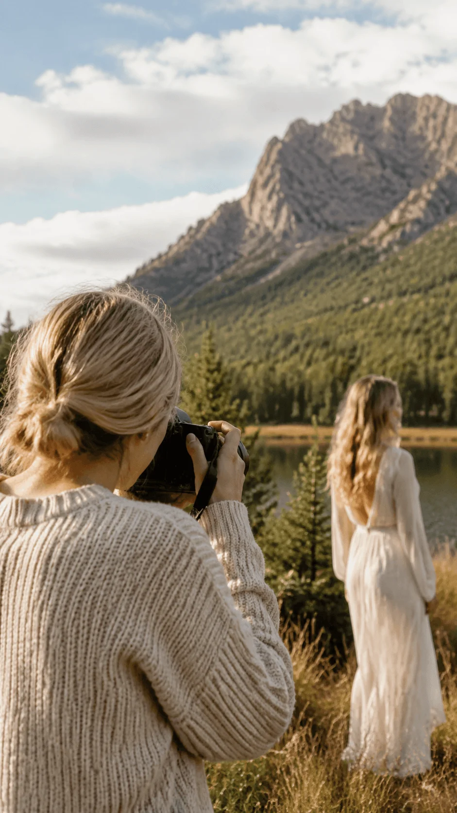 Natural light photography session showing a photographer capturing a portrait outdoors near a mountain lake with soft sunlight and a peaceful natural landscape background
