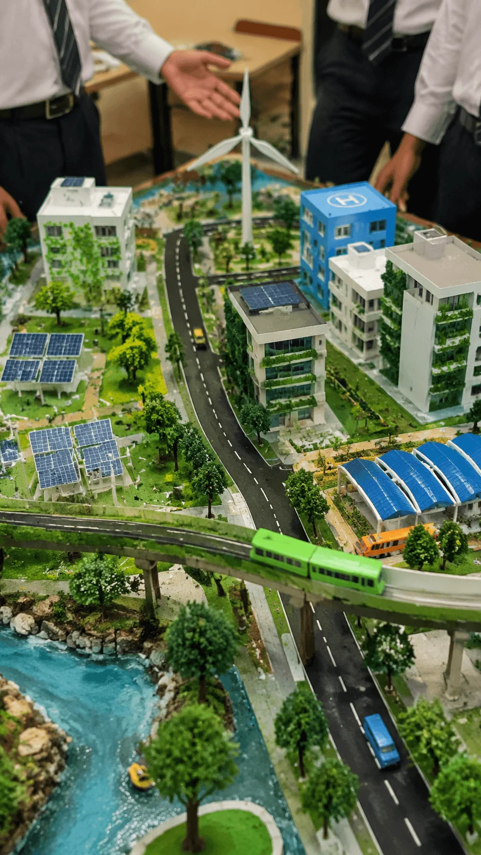 Students presenting a smart city model project featuring renewable energy solar panels green buildings sustainable transport and eco friendly urban planning concepts