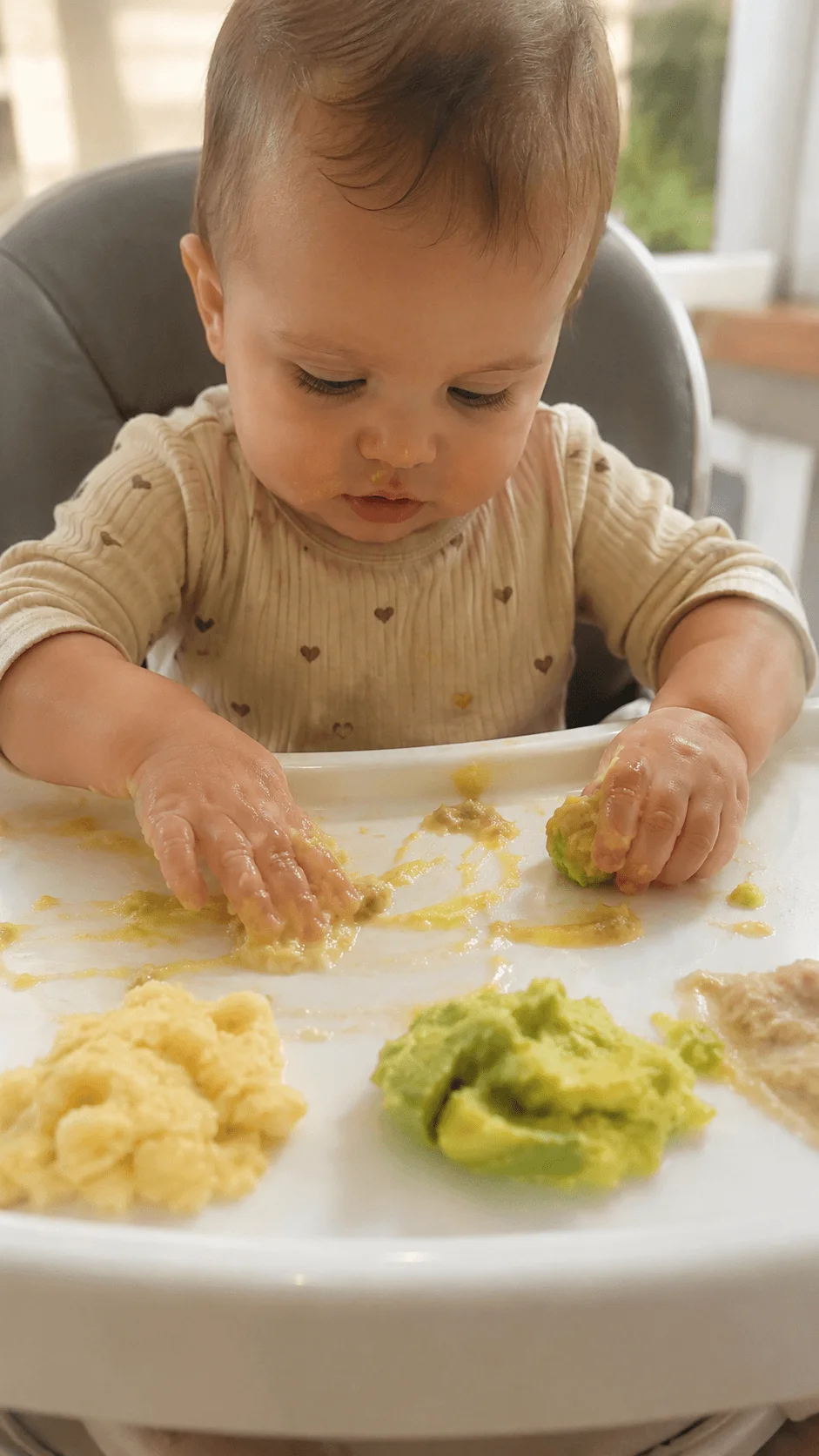 Baby exploring taste safe leftover food during sensory play