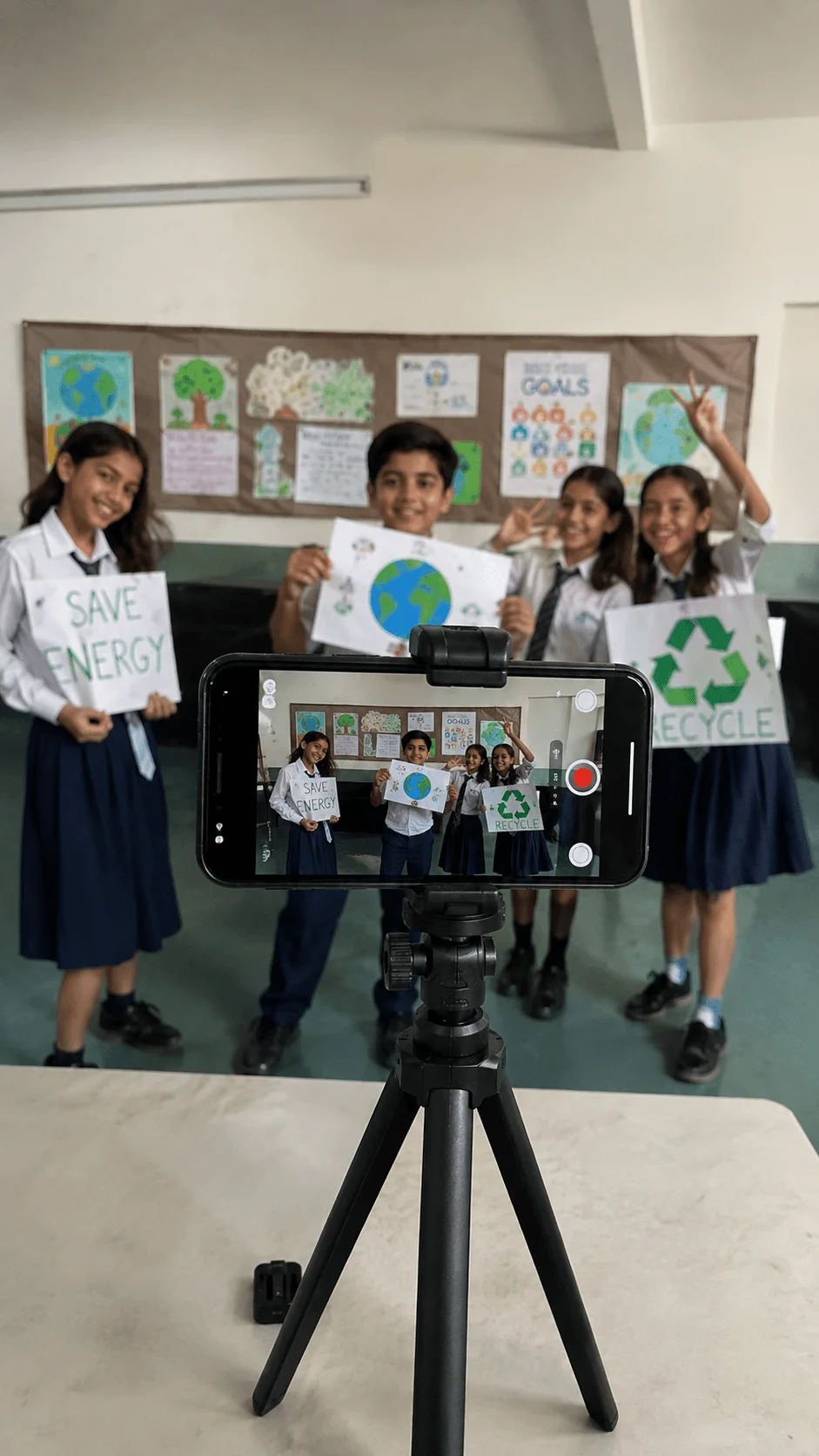 Students recording a climate action video at school while holding save energy recycling and Earth awareness posters