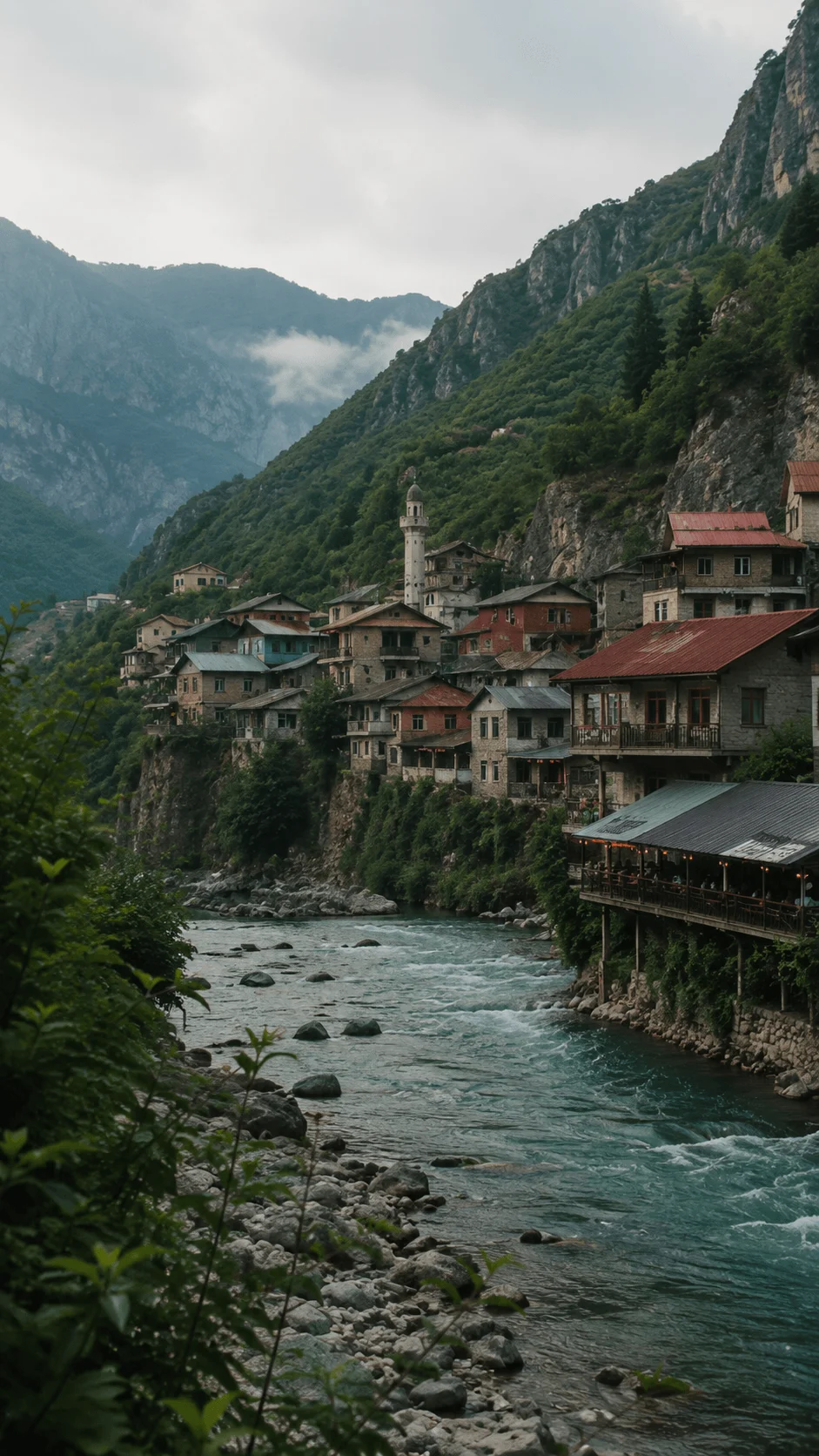 Hidden destination featuring a peaceful mountain village beside a flowing river surrounded by lush green cliffs