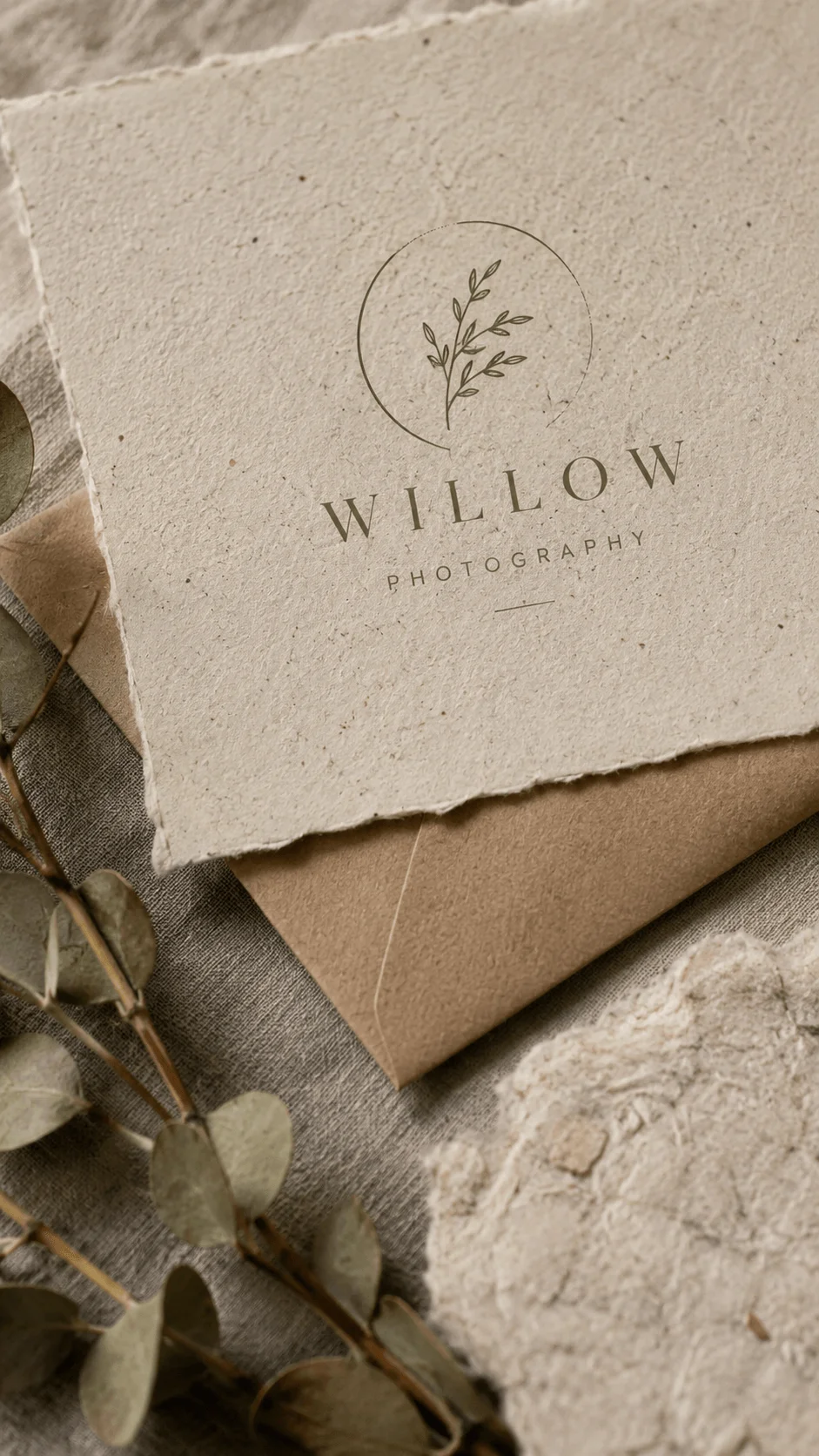 Recycled paper texture logo design featuring a minimalist leaf symbol and elegant Willow photography branding on natural handmade paper with dried leaves and earthy materials