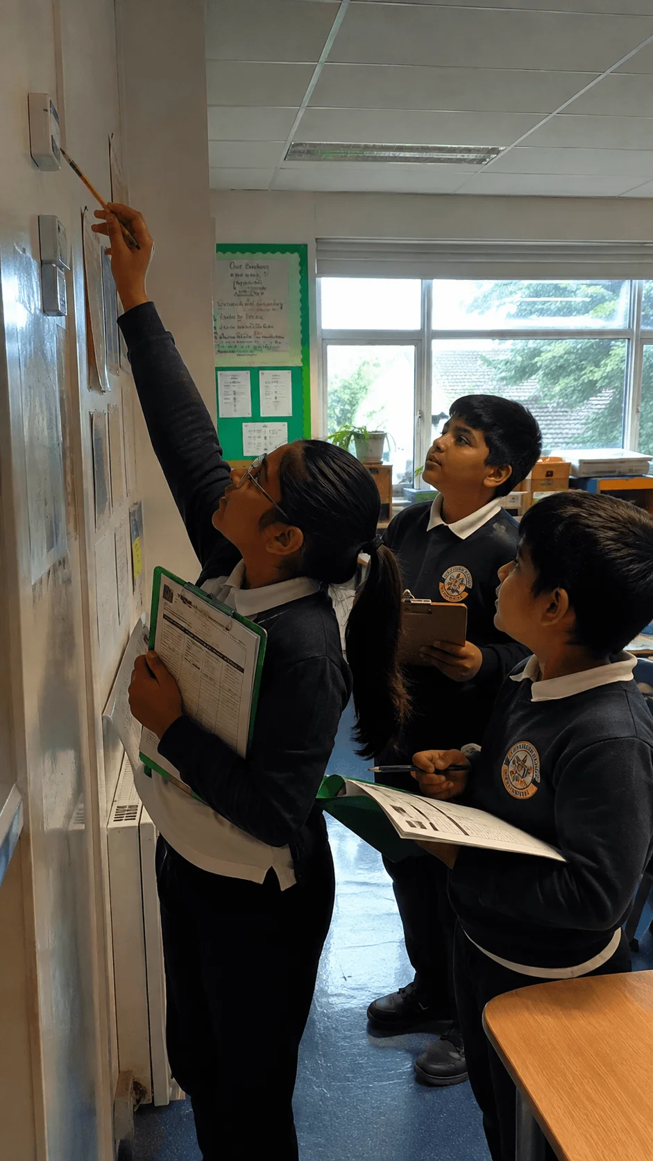 Students conducting a school energy audit by checking classroom controls and recording energy use observations