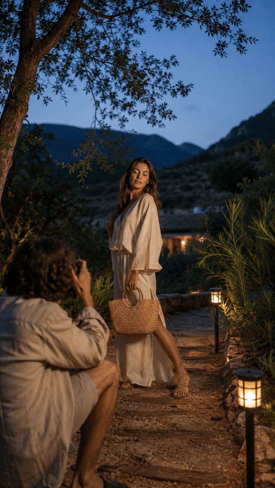 Photographer capturing outdoor portrait with solar powered lights in a natural landscape during twilight with mountains trees and warm eco friendly illumination